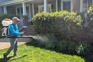Pest control technician applying bug spray for interior of house walls and using the best pesticide for homes in Kearney, Nebraska.