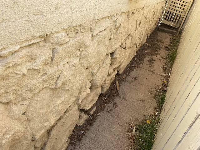 Exterior stone foundation wall showing potential gaps and entry paths for rodents