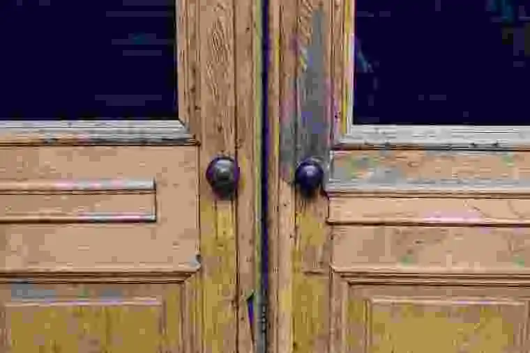 An old weathered wooden door showing signs of damage that requires thorough pest inspection services.